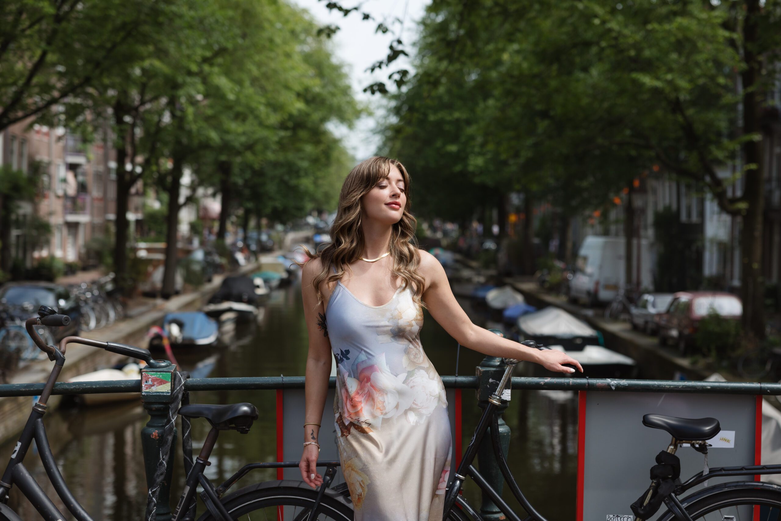 portrait on amsterdam bridge with canal in background